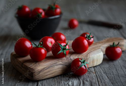 Fresh ripe organic cherry tomatoes on dark background
