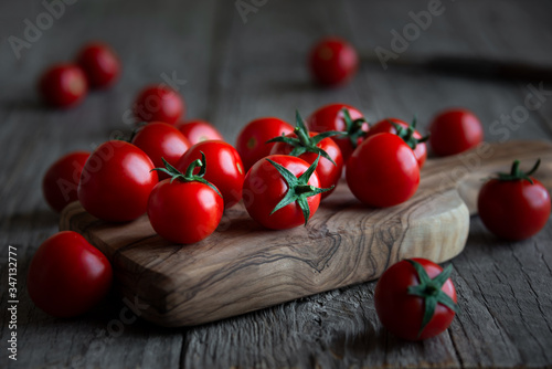Fresh ripe organic cherry tomatoes on dark background