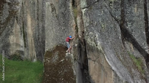 climber climbing a rock with drone
