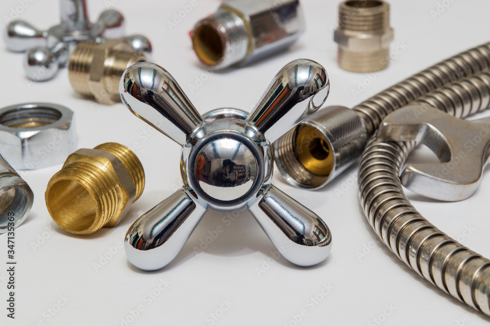 All kinds of plumbing and tool on a gray background with place for inscription or advertisement All kinds of plumbing and tool on a gray background with place for inscription or advertisement