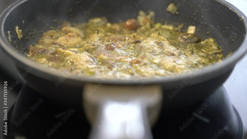 Preparing pesto sauce with mushrooms on induction, loopable Preparing pesto sauce with mushrooms on induction, loopable
