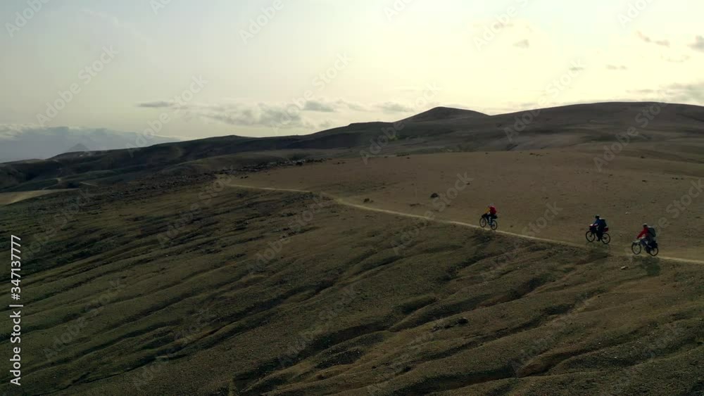 Amazing aerial drone shot of people riding on a path in Iceland Amazing aerial drone shot of people riding on a path in Iceland