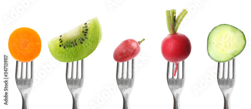 Forks with different vegetables and fruits on white background, banner design. Healthy meal