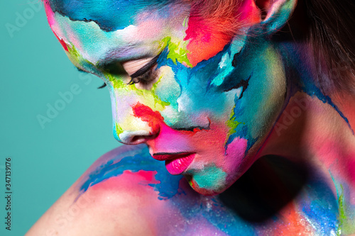 Fashion and creative makeup, young beautiful woman abstract face art,