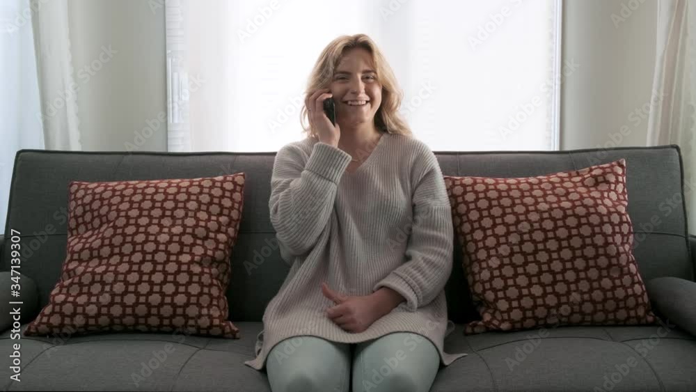 Young attractive woman laughing and smiling on a phone call Young attractive woman laughing and smiling on a phone call