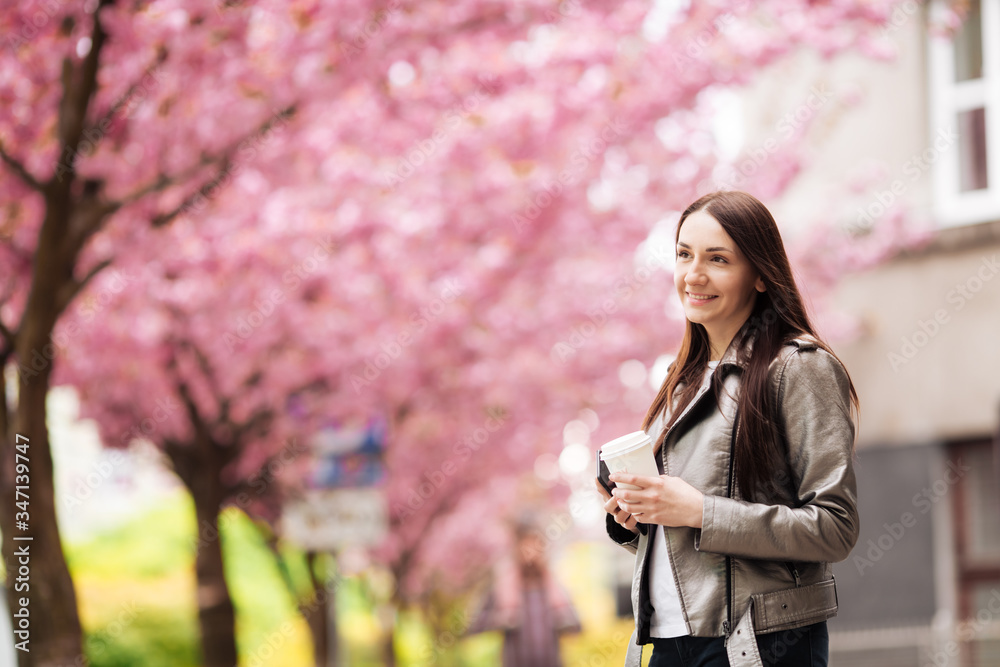 Beautiful European girl near a Japanese tree Beautiful European girl near a Japanese tree