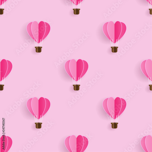 Seamless pattern with heart hot air balloon paper art style on light pink background