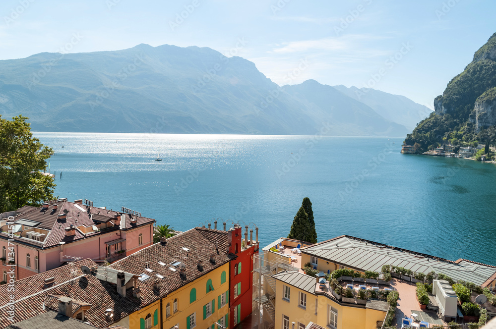Aerial view on lake Garda and  tile roofed houses on mountain range background