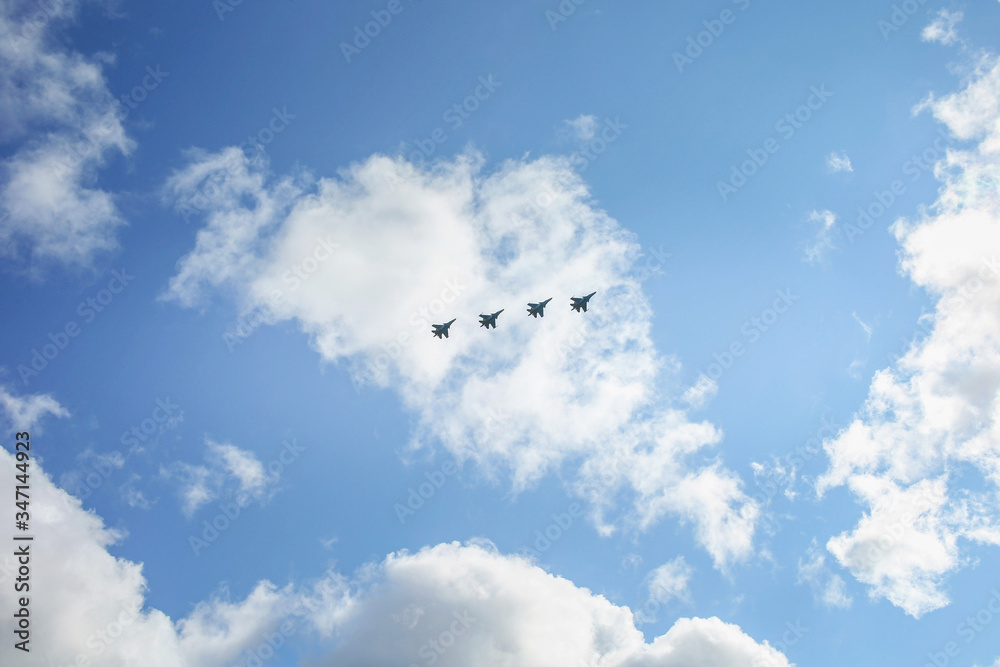 Fototapeta premium A group of warplanes flying at the blue sky
