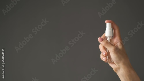 Doctor is a girl of Caucasian appearance holding an antiseptic in her hands and applying it on her hands photo