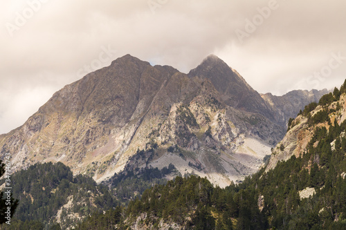 Mountainous landscape with rocky peaks and clouds