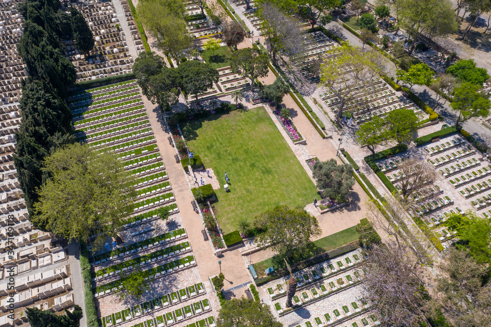 Naklejka premium Military Cemetery at Memorial Day with Waving flag and Army officers in White uniform, Aerial view.
