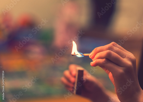 The child lighting the matches. The fire in the hands of a child. A small child plays with matches, a fire, a fire flares up, danger, child and matches, lucifer match. toned