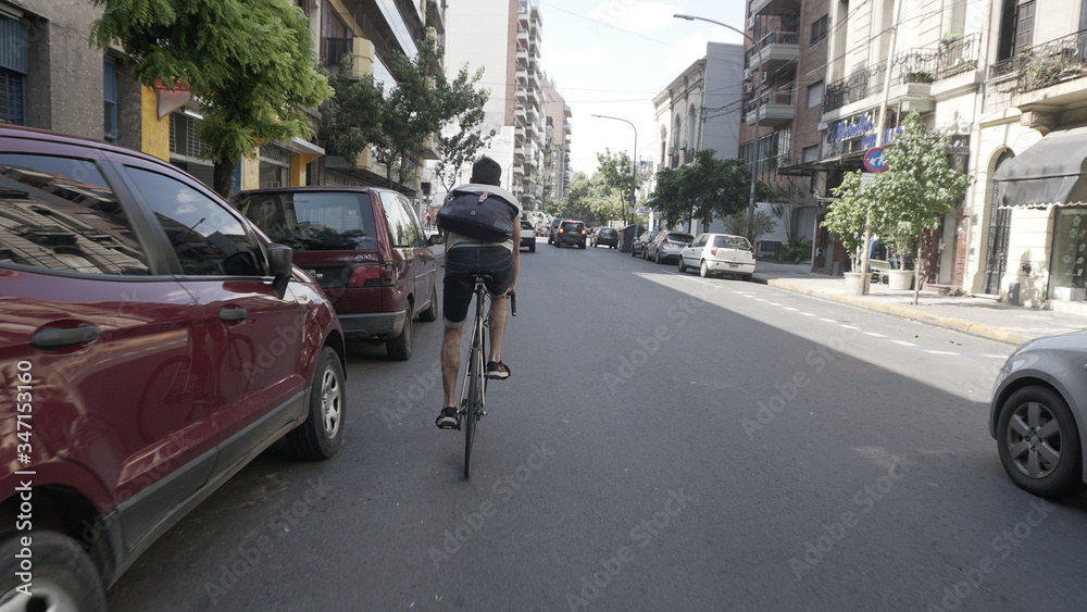 a guy riding his bike through Buenos Aires.