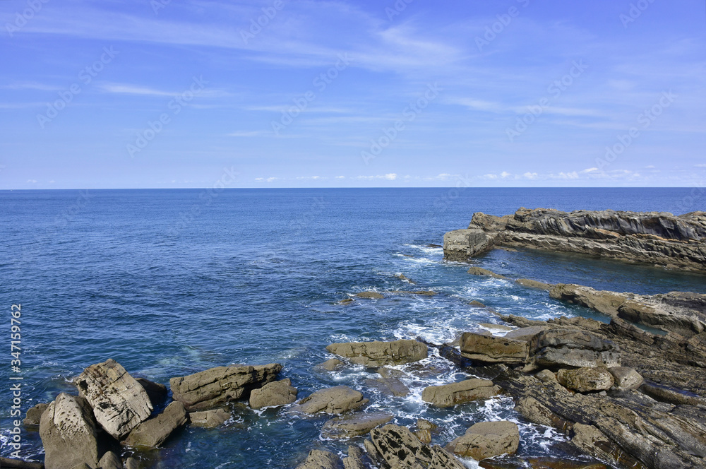 views of the rocky shoreline on blue day