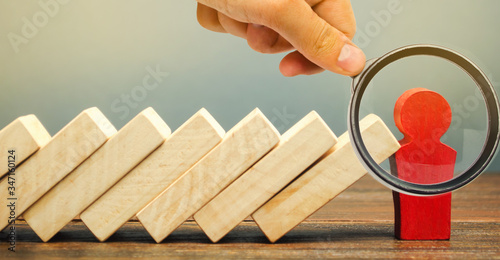 Businessman stops domino falling. Risk management concept. Successful strong business and problem solving. Reliable leader. Stop the destructive processes. Strategy development. Debt restructuring
