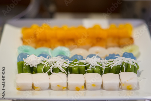 Thai beautiful color sweet gelatin topped with slice coconut photo