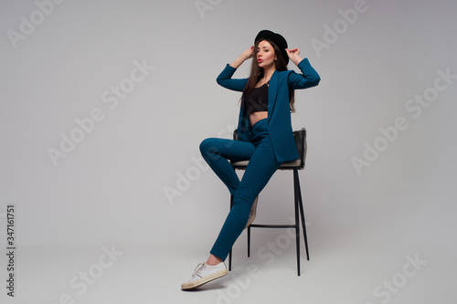 stylish business woman in a dark blue pantsuit.