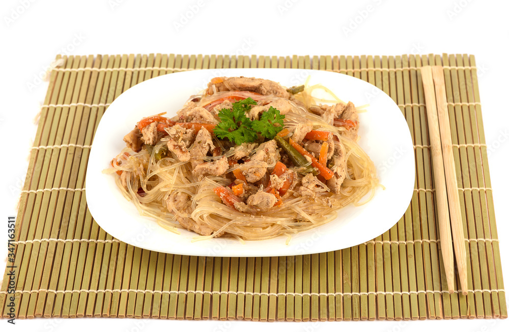 Funchosa with pork and vegetables on a mat with chopsticks. Funchosa with pork and vegetables on a mat with chopsticks.