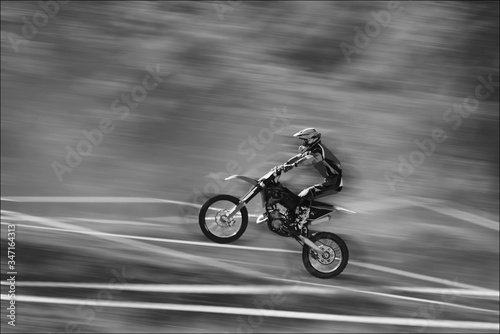 The motorcyclist is landing. Motocross. Sports. A moving blur background. B w