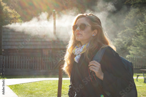 Young woman walking in the park.Woman in the fog