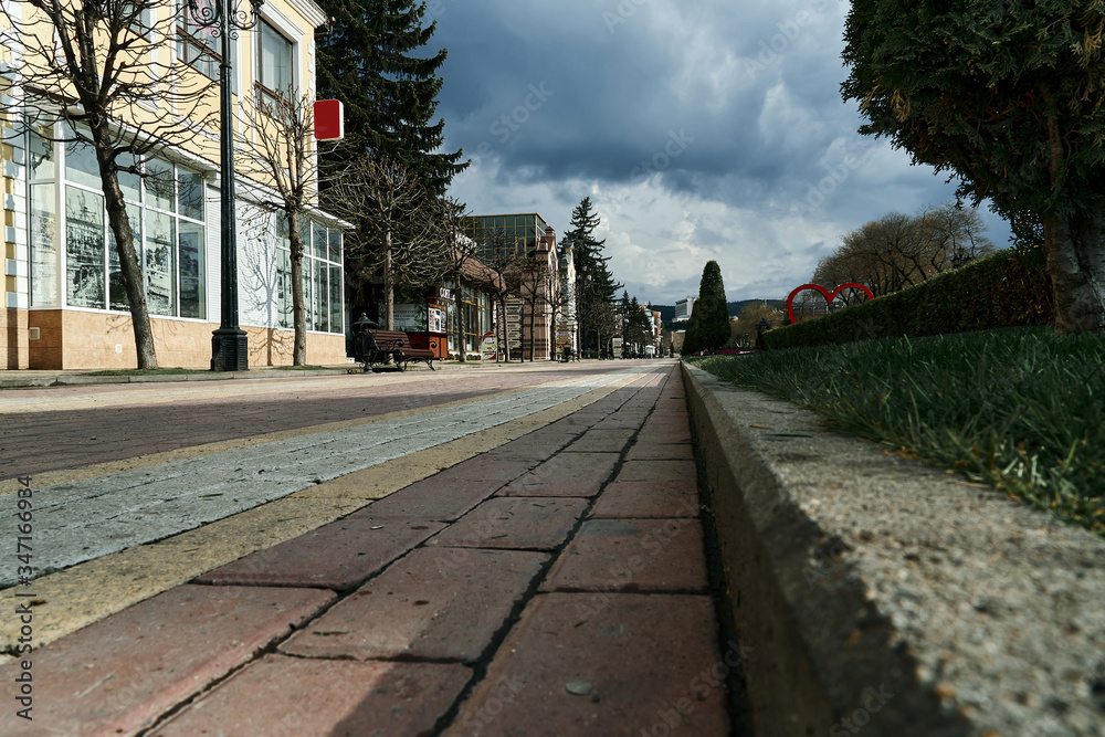 City center resort Kislovodsk in Russia. Empty resort boulevard during the epidemic of the corona virus in Russia. Old and new buildings along the walking paths in the city. Cloudy weather after rain.