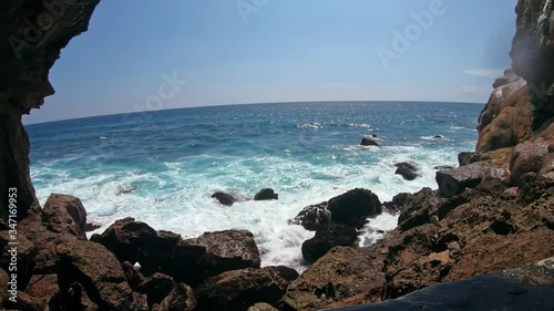 First-person  of a person go to a cliff on a high mountain with a sea and rock sview photo