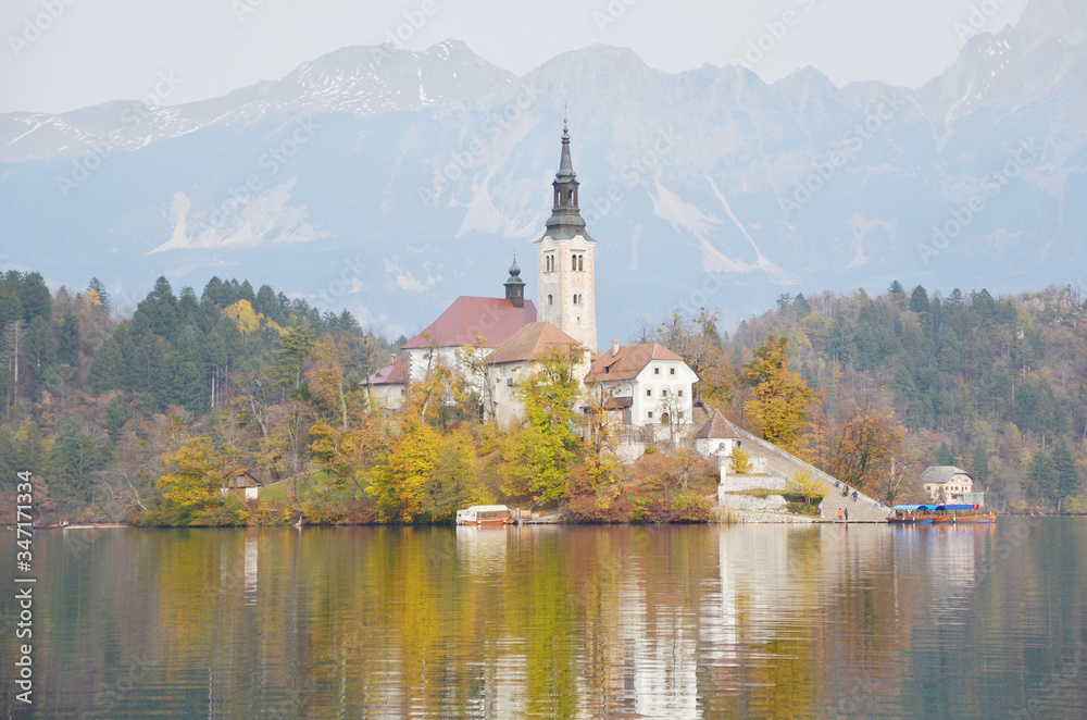 Lake Bled’s famous island with a church rests in the middle of the lake. Assumption of Mary Pilgrimage Church in the middle of Lake Bled.