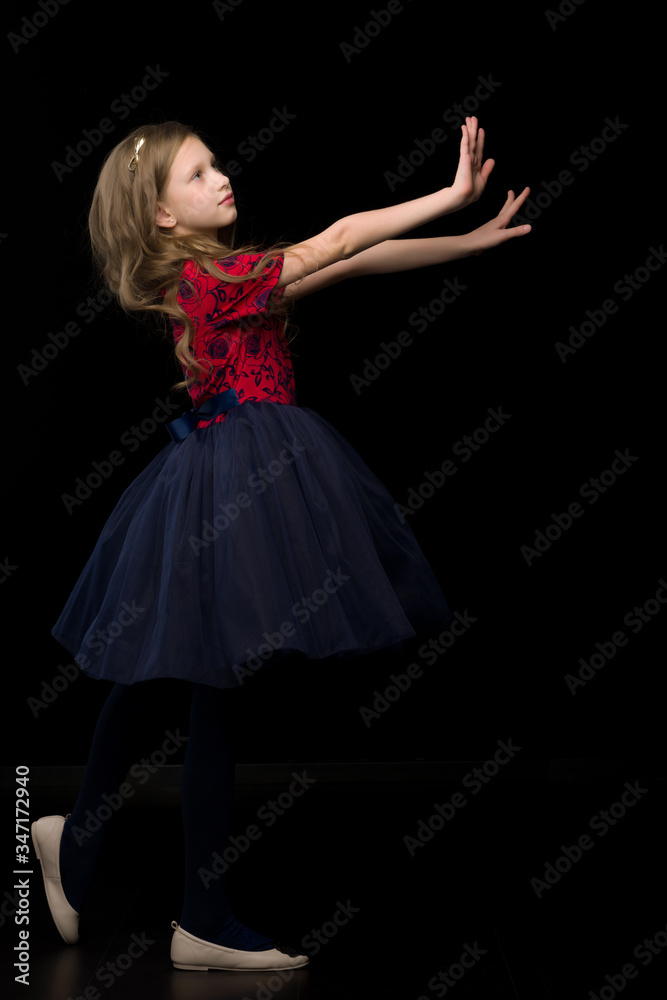 Side View of Pretty Girl in Tutu Dress Holding Hands in front of