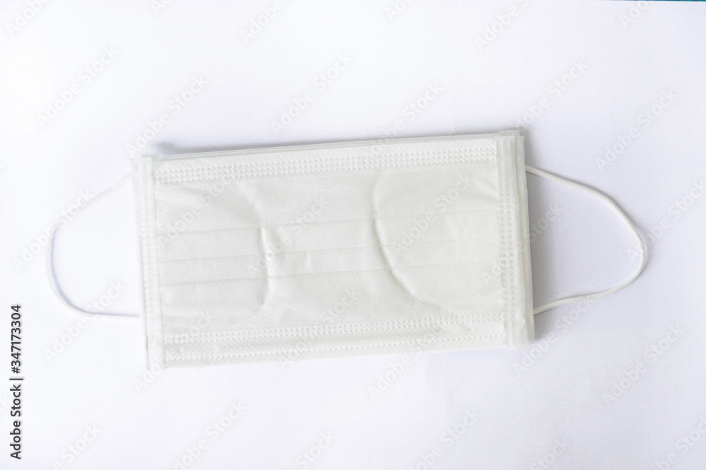 Clean white surgical face mask with wrinkle after unpack for protection PM 2.5 and virus put on isolated background Clean white surgical face mask with wrinkle after unpack for protection PM 2.5 and virus put on isolated background