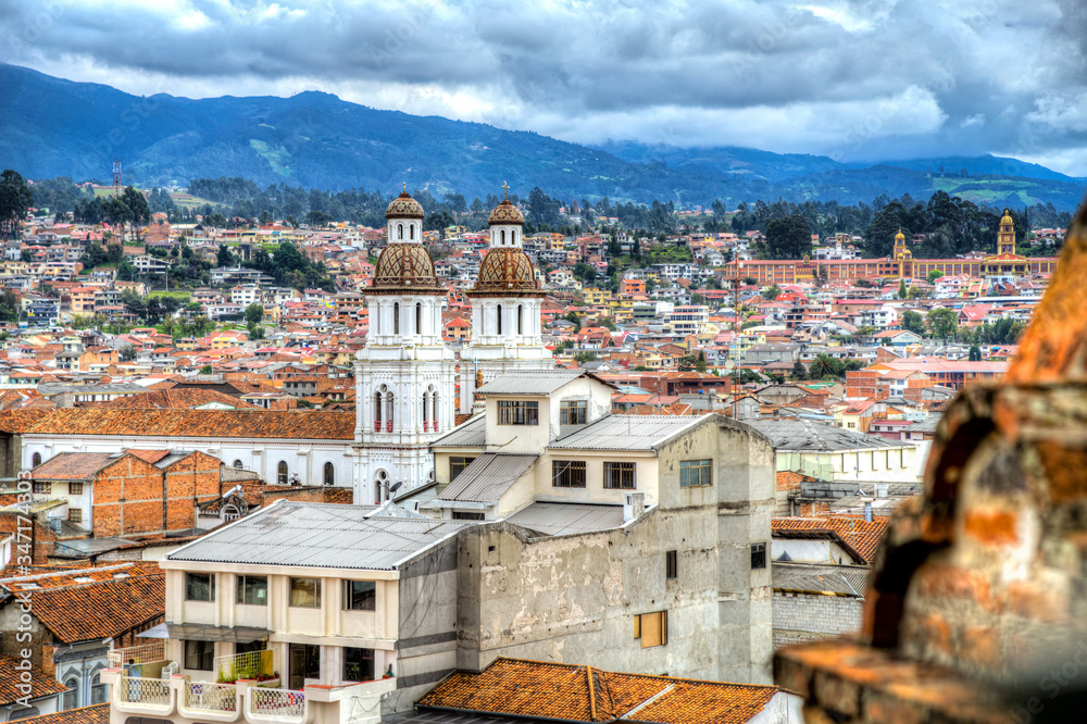 View of the city of Cuenca, with it's many churches, cathedrals and houses, in the middle of the Ecuadorian Andes, on a sunny afternoon, Ecuador, South America.