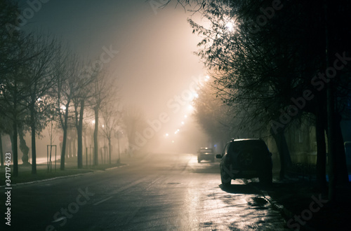  Street road of a night city with cars in wet cold rainy weather