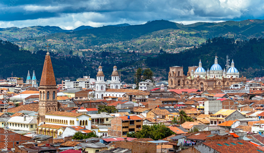 View of the city of Cuenca, with it's many churches, cathedrals and houses, in the middle of the Ecuadorian Andes, on a sunny afternoon, Ecuador, South America.