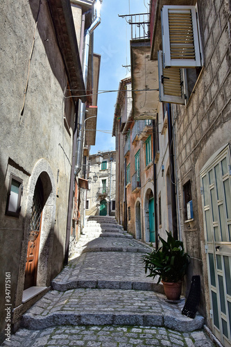 Fototapeta Naklejka Na Ścianę i Meble -  A narrow street between old buildings in the medieval town of Cusano Mutri, in the province of Avellino