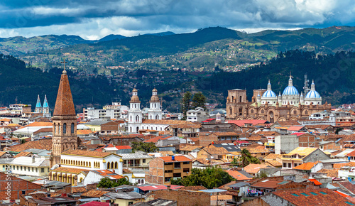 View of the city of Cuenca, with it's many churches, cathedrals and houses, in the middle of the Ecuadorian Andes, on a sunny afternoon, Ecuador, South America. photo