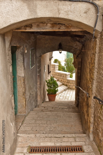 A narrow street between old buildings in the medieval town of Cusano Mutri, in the province of Avellino photo