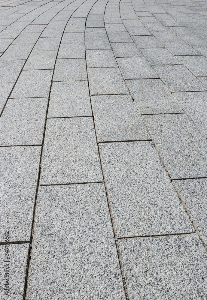 A pavement made of rectangular stone slabs.
