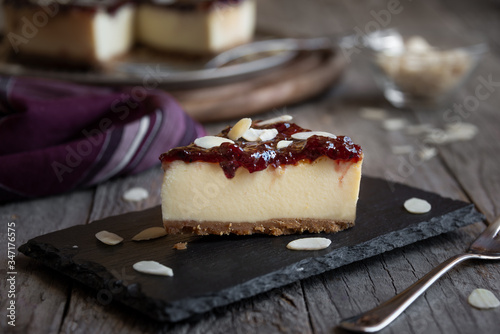 Homemade delicious cheesecake with fruit jam and almonds