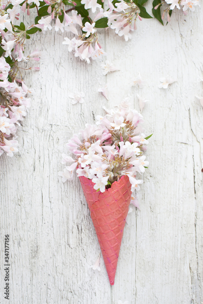 Bouquet - flower ice cream. Pink flowers in an ice cone
