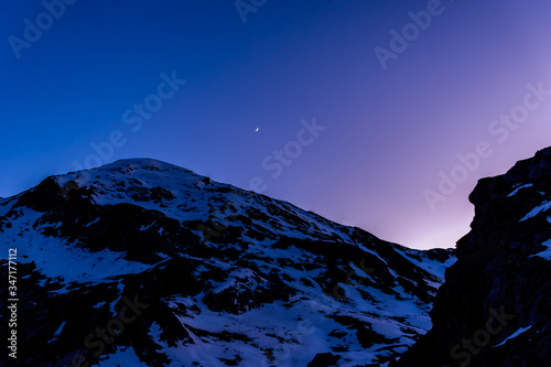 A picturesque landscape view of the snow capped Pyrenees mountain range in the dusk