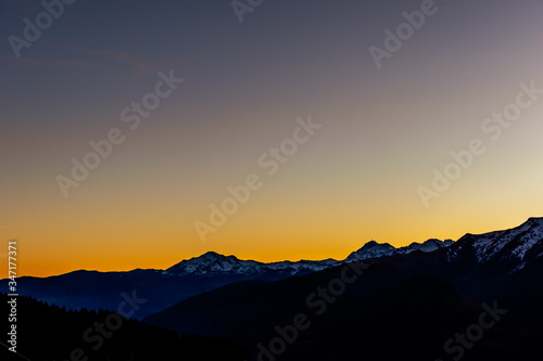 A picturesque landscape view of the silhouette of the French Pyrenees mountain range early in the morning at dawn before sunrise (Col de Soum)