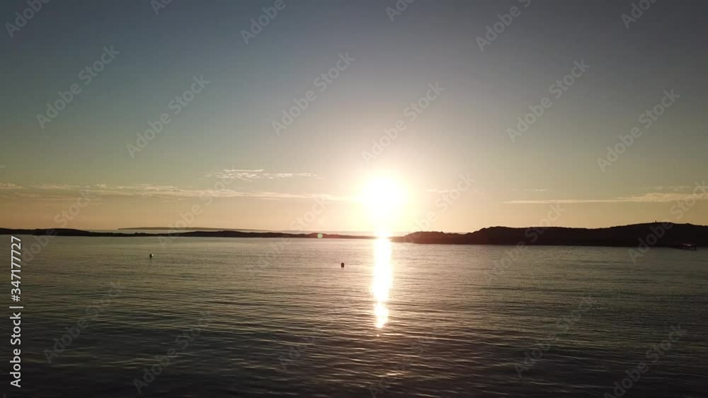 Shot of a flight over the sea to the sun at sunrise, water glare and clear sky in the Balearic Islands of Spain. Shot of a flight over the sea to the sun at sunrise, water glare and clear sky in the Balearic Islands of Spain.