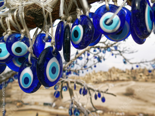 Evil eye bead hanging on tree