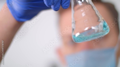 Male doctor testing a cure for the virus. Video with light background.