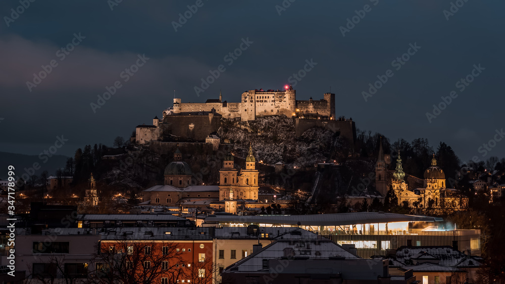 Festung hohensalzburg and Salzburg Cathedral with light on in th