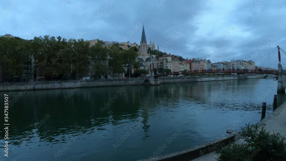 DOLLY SHOT Church of St George with buildings along the Saone River, Quai Fulchiron (quay), in the Old City of Lyon, in the 5th arrondissement (district), Passerelle St-Georges and the Fourviere hill. DOLLY SHOT Church of St George with buildings along the Saone River, Quai Fulchiron (quay), in the Old City of Lyon, in the 5th arrondissement (district), Passerelle St-Georges and the Fourviere hill.
