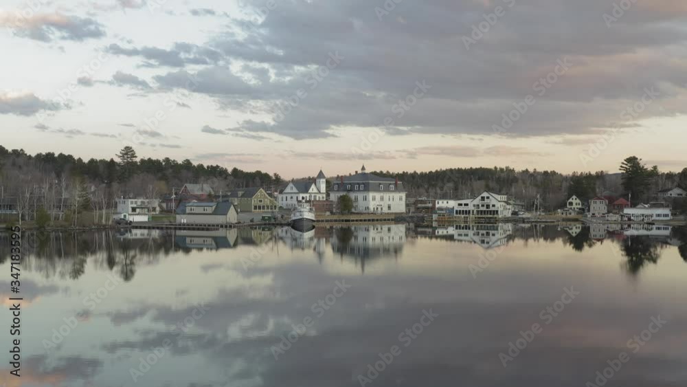 Nearly vacant downtown reflecting in a calm lake after a spring sunset AERIAL Nearly vacant downtown reflecting in a calm lake after a spring sunset AERIAL
