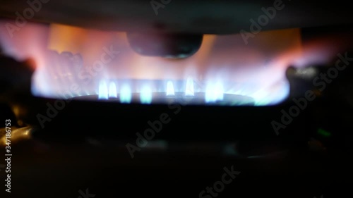Close up of burning blue yellow orange flame on a cooking kitchen gas stove