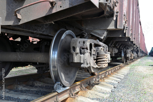 A train carrying industrial goods. The wheels of the car.