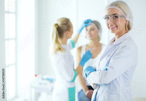 Beautiful woman face near doctor with syringe.